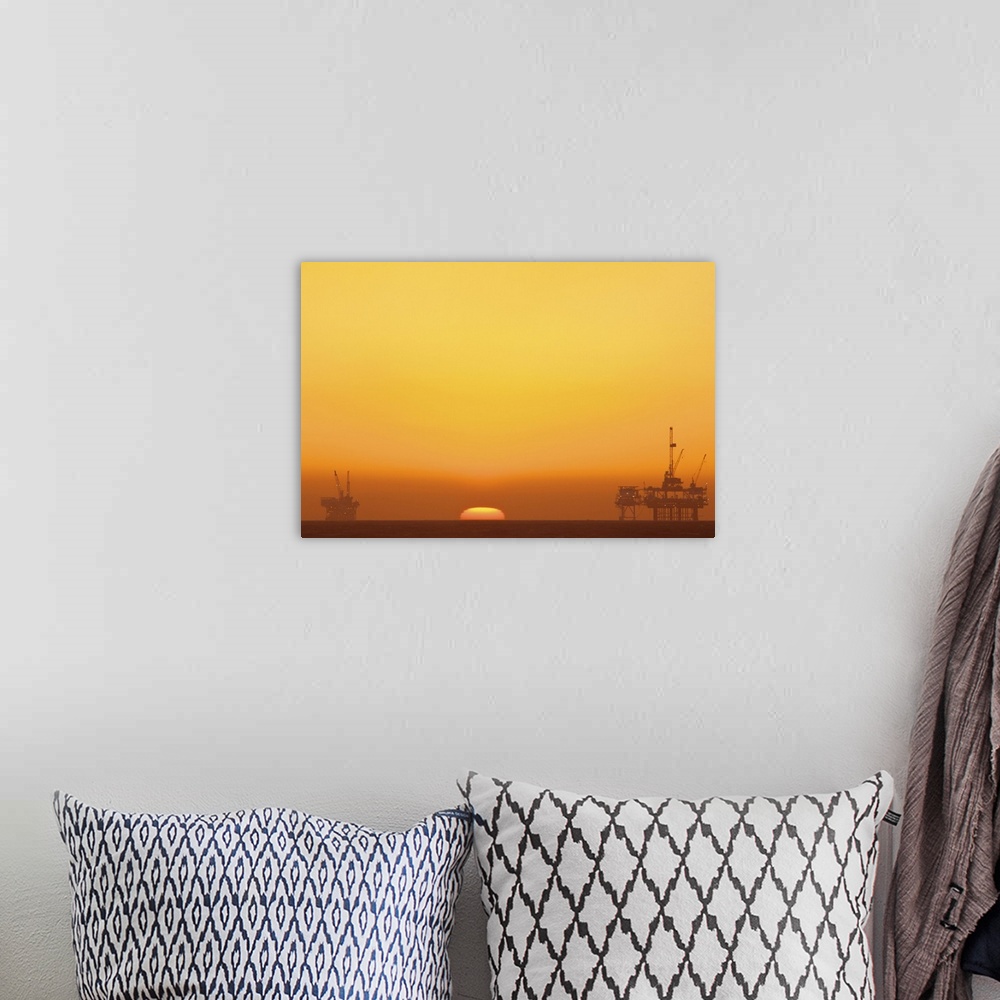 A bohemian room featuring Huntington beach with oil rig during sunset.