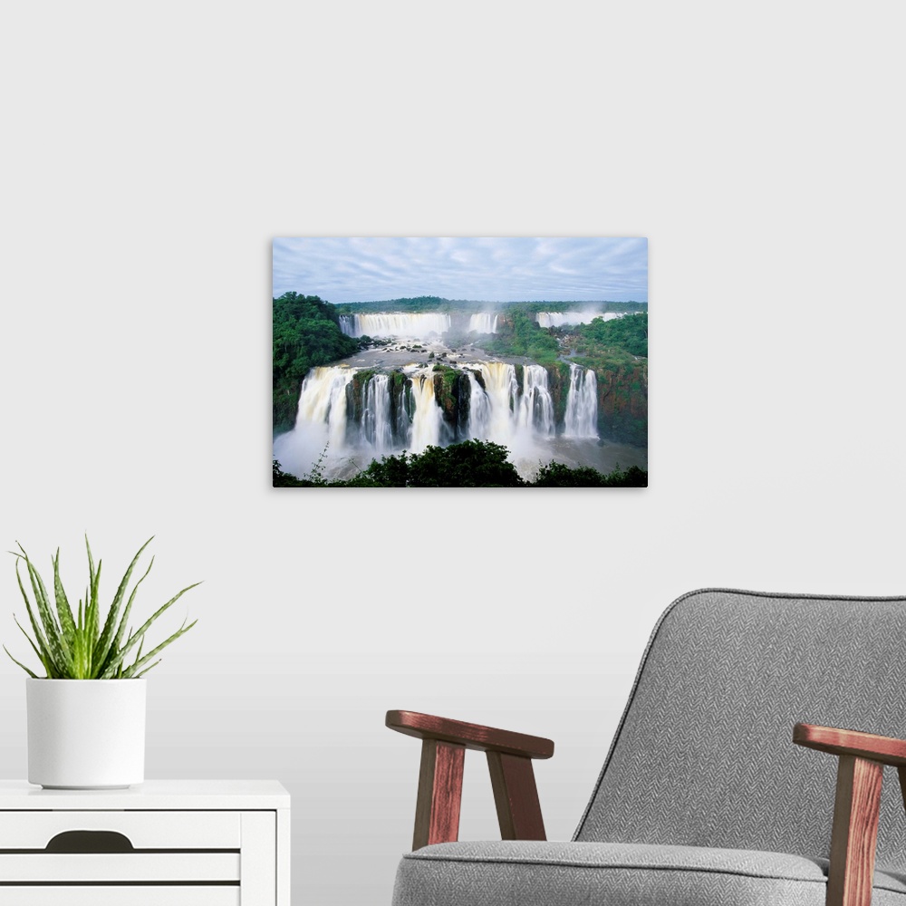 A modern room featuring A view of the Iguazu Waterfalls located in the Parque Nacional Iguazu in Brazil and Argentina.