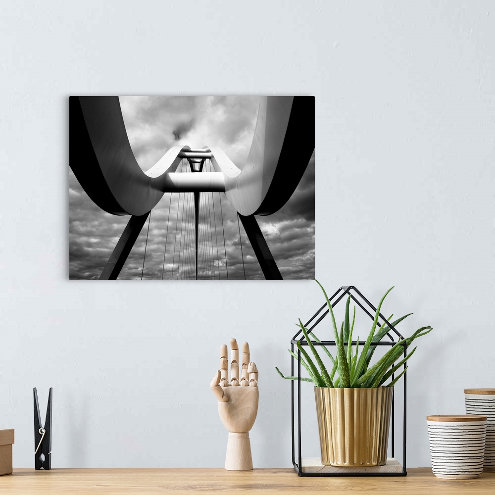 A bohemian room featuring A black and white photograph taken from below the infinity bridge in the UK and looking up to the...
