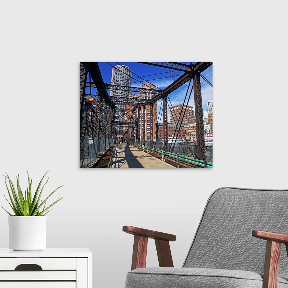 A modern room featuring Iron footbridge with Boston Financial district in background