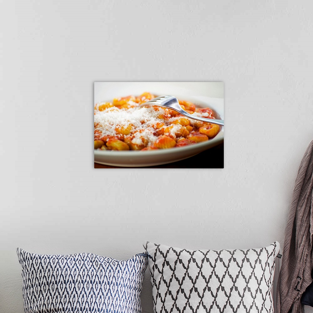 A bohemian room featuring Italian gnocchi with parmesan cheese and tomato sauce