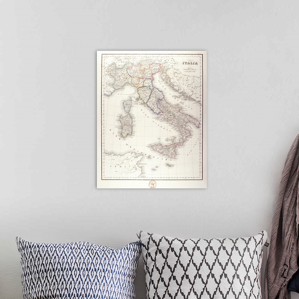 A bohemian room featuring An antique map of Italy that has the wording in Italian.