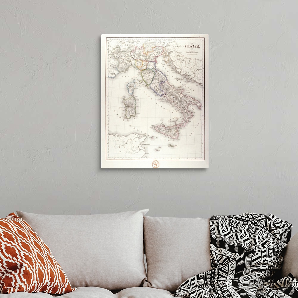 A bohemian room featuring An antique map of Italy that has the wording in Italian.
