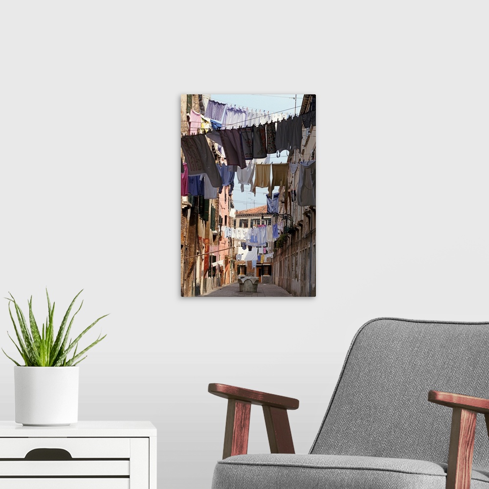 A modern room featuring Italy, Venice, lines of washing hanging between buildings in sunny street