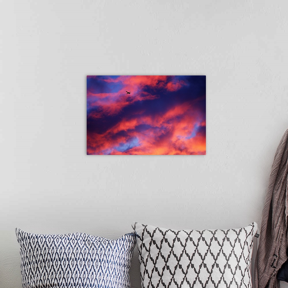 A bohemian room featuring Jet Among Clouds At Sunset