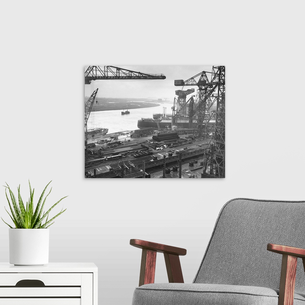 A modern room featuring A view of John Brown's Shipyards at Glasgow. Looking along the curving river Clyde, scene of many...