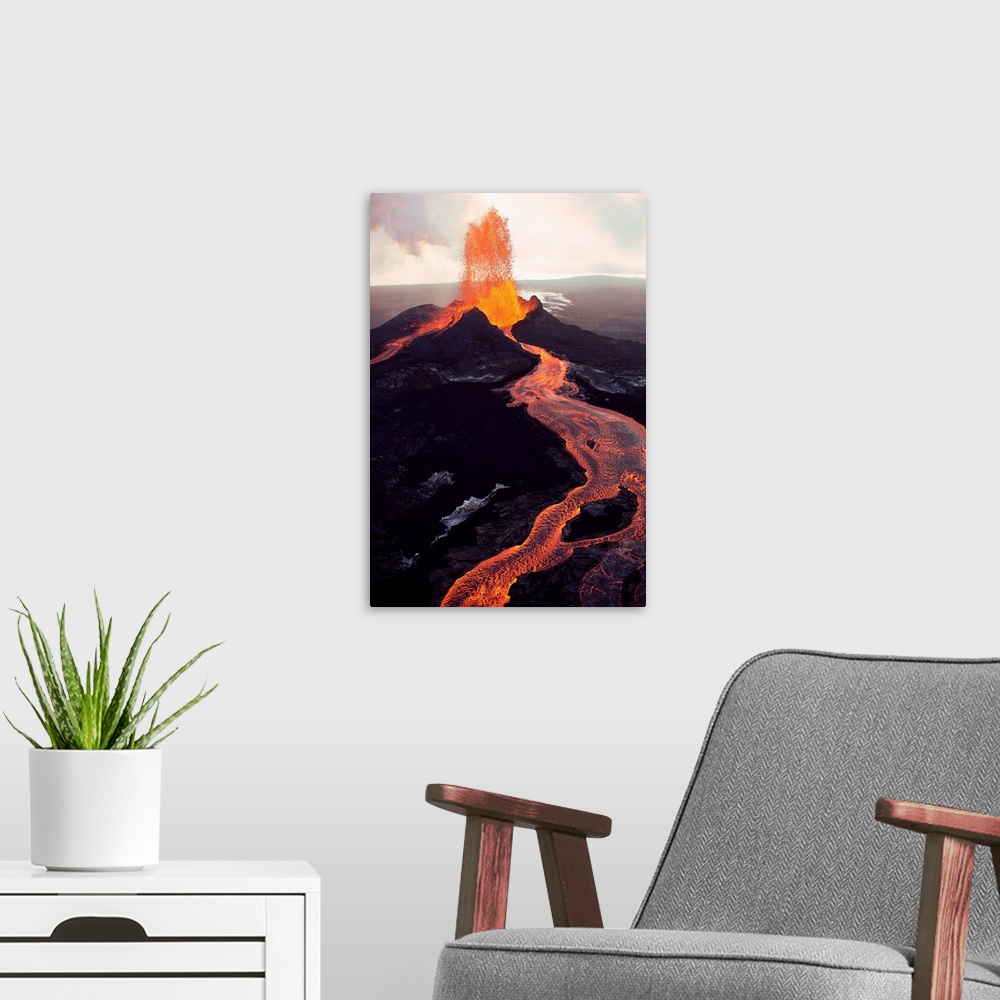 A modern room featuring Puu Oo, the easternmost of Kilauea's volcanic vents, spews molten lava.