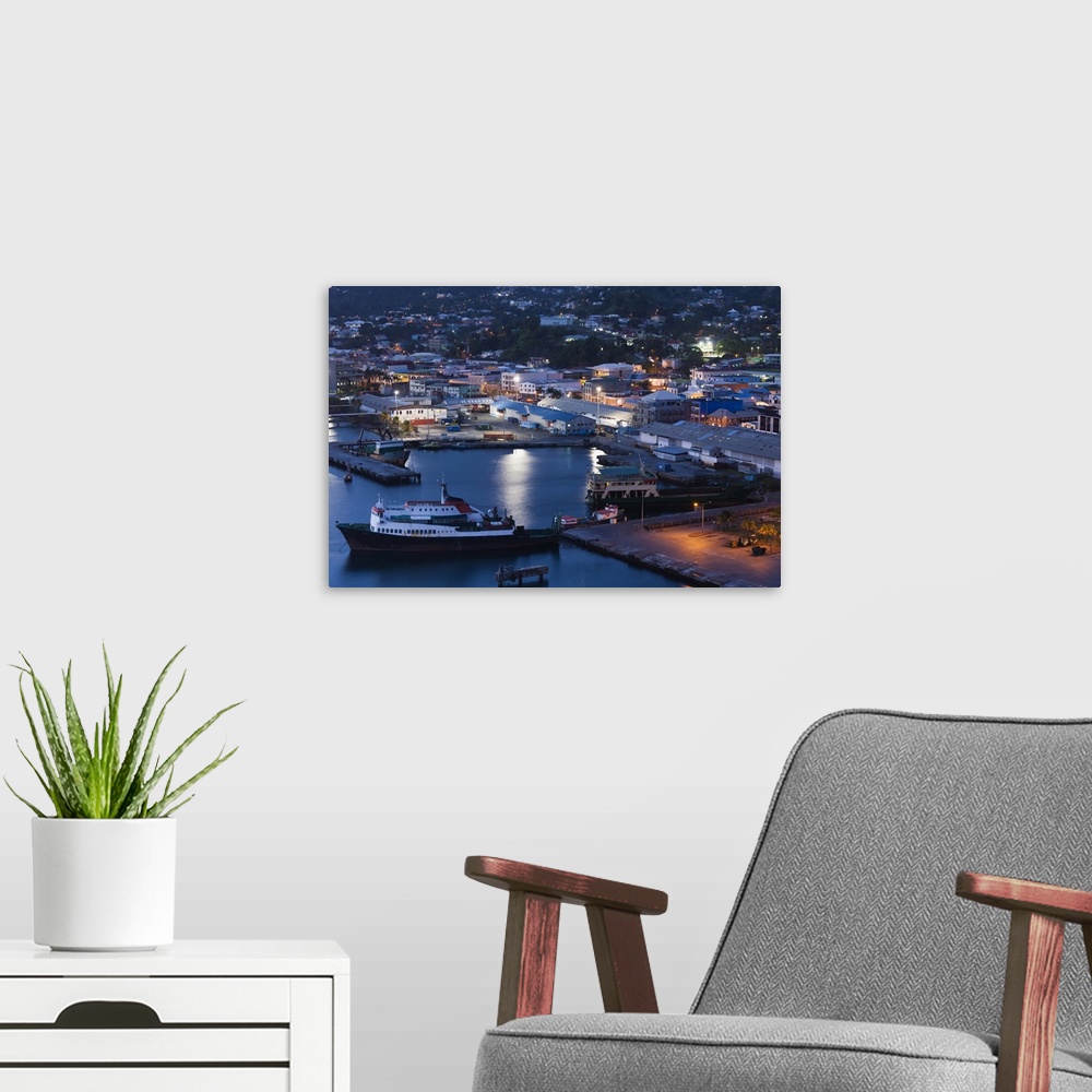 A modern room featuring St. Vincent and the Grenadines, St. Vincent, Kingstown, elevated city view, dusk.