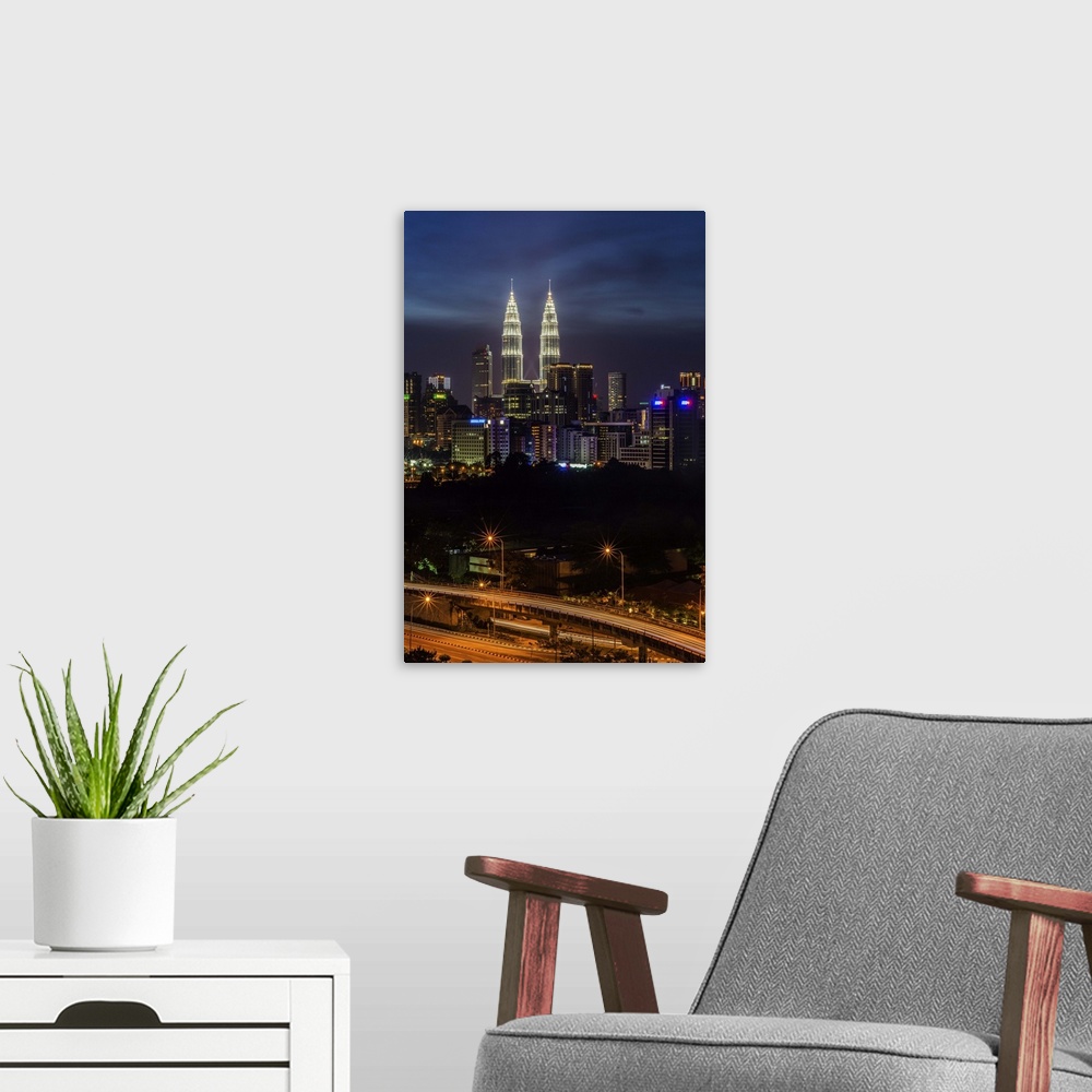 A modern room featuring KLCC in view, with the elevated highway as foreground. Dramatic view of Kuala Lumpur (KL)