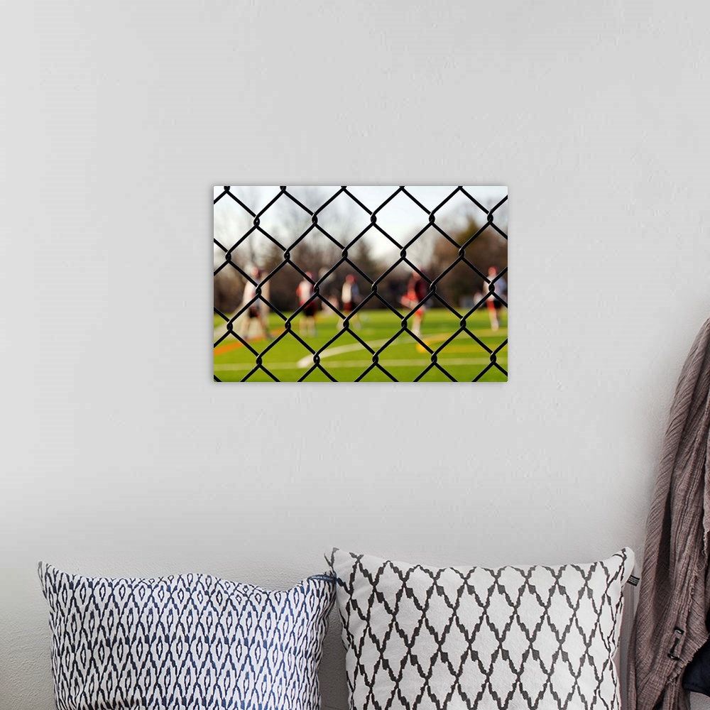 A bohemian room featuring Lacrosse team behind a fence