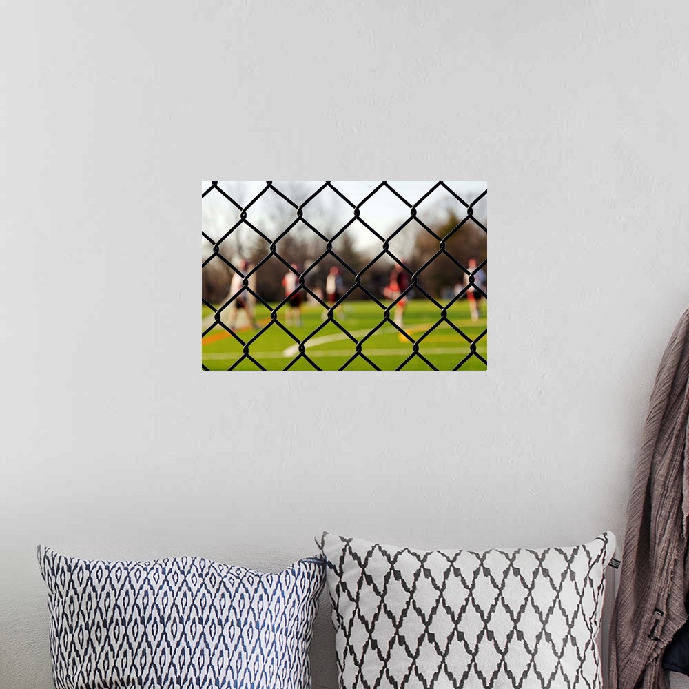 A bohemian room featuring Lacrosse team behind a fence