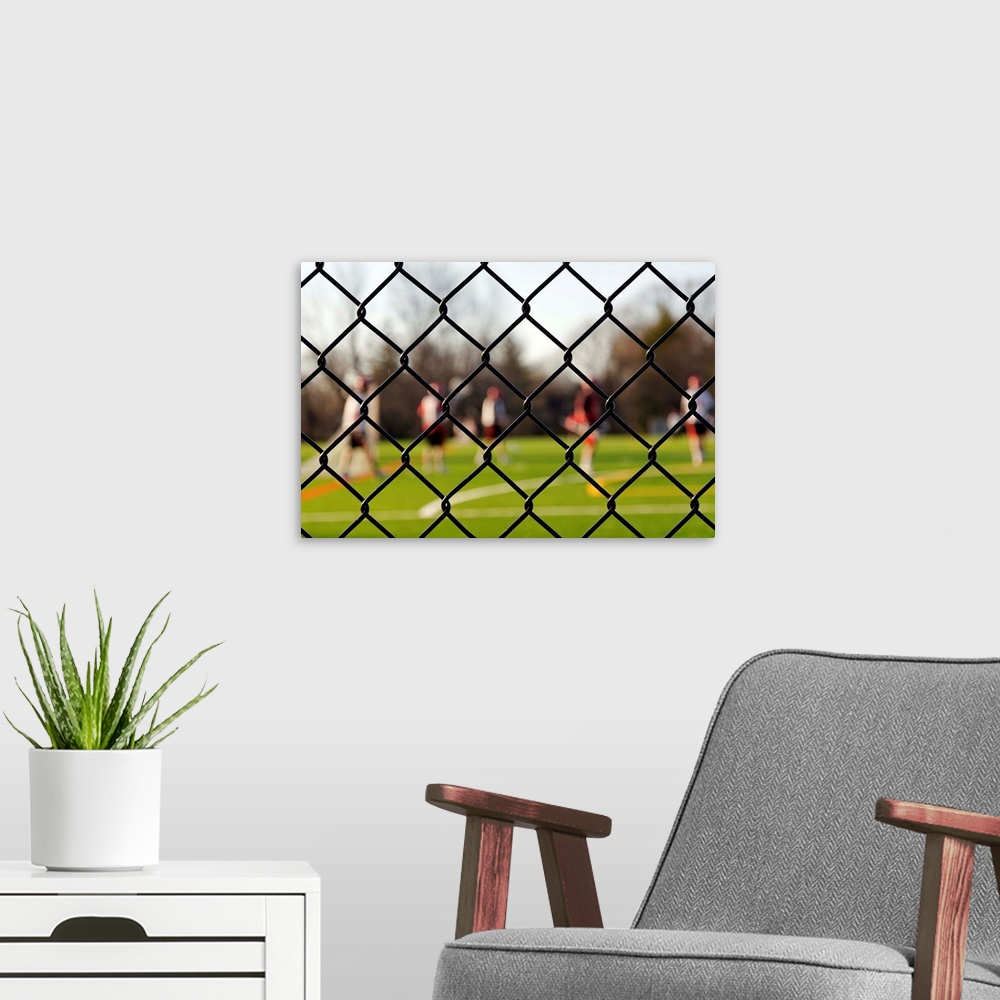 A modern room featuring Lacrosse team behind a fence