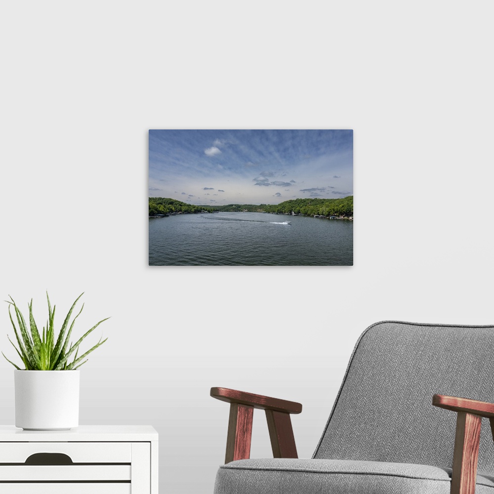 A modern room featuring A scenic lake landscape with a speeding boat.
