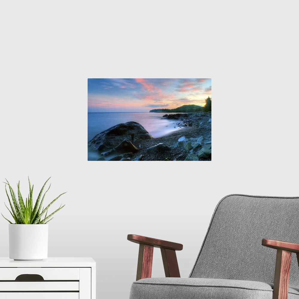 A modern room featuring Beautiful summer sunset along rocky shore of Lake Superior.