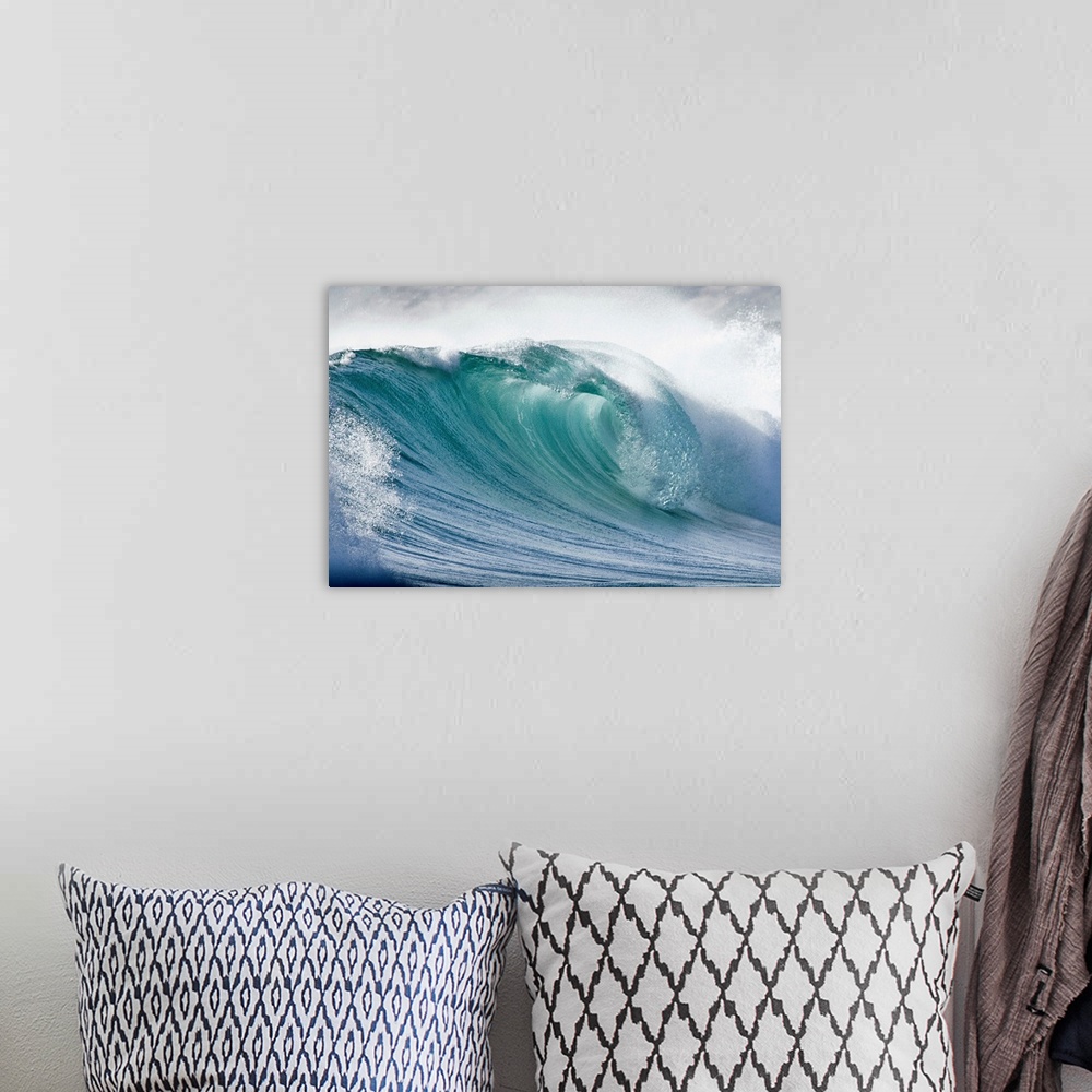 A bohemian room featuring Up close photograph of huge swell crashing and creating sea foam and spray.