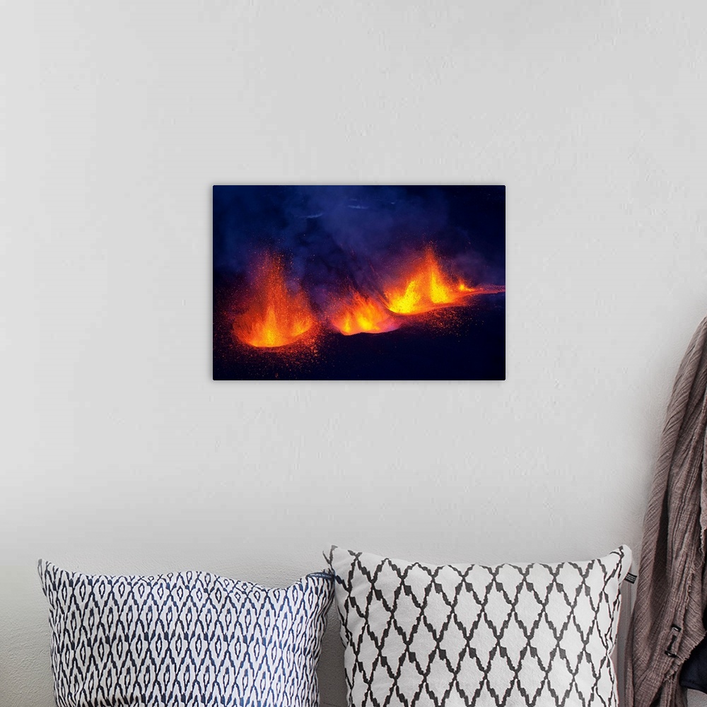 A bohemian room featuring Lava fountains spurting during volcano eruption in Iceland at Fimmvorduhals, a ridge between Eyja...