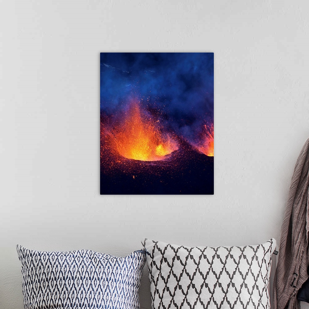 A bohemian room featuring Lava fountains spurting during volcano eruption in Iceland at Fimmvorduhals, a ridge between Eyja...