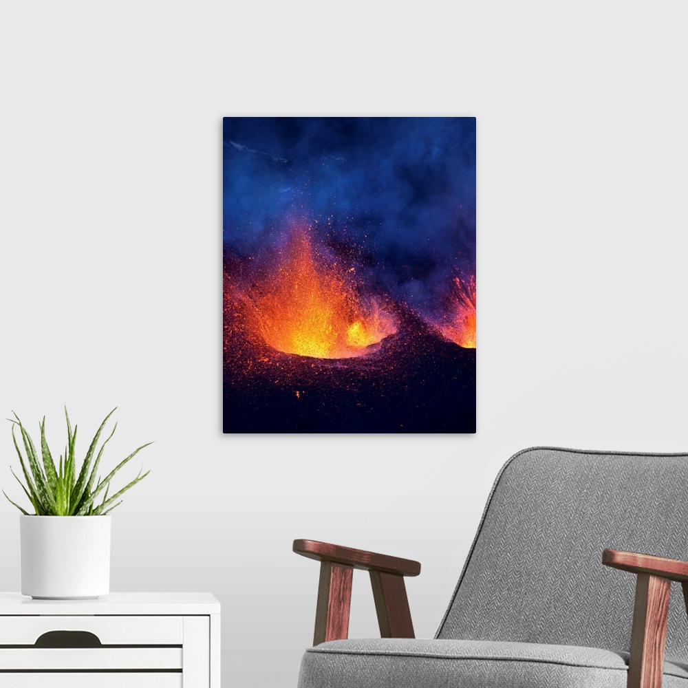 A modern room featuring Lava fountains spurting during volcano eruption in Iceland at Fimmvorduhals, a ridge between Eyja...