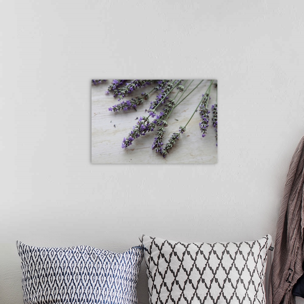 A bohemian room featuring Big photo on canvas of lavender flowers laying on a wooden surface.