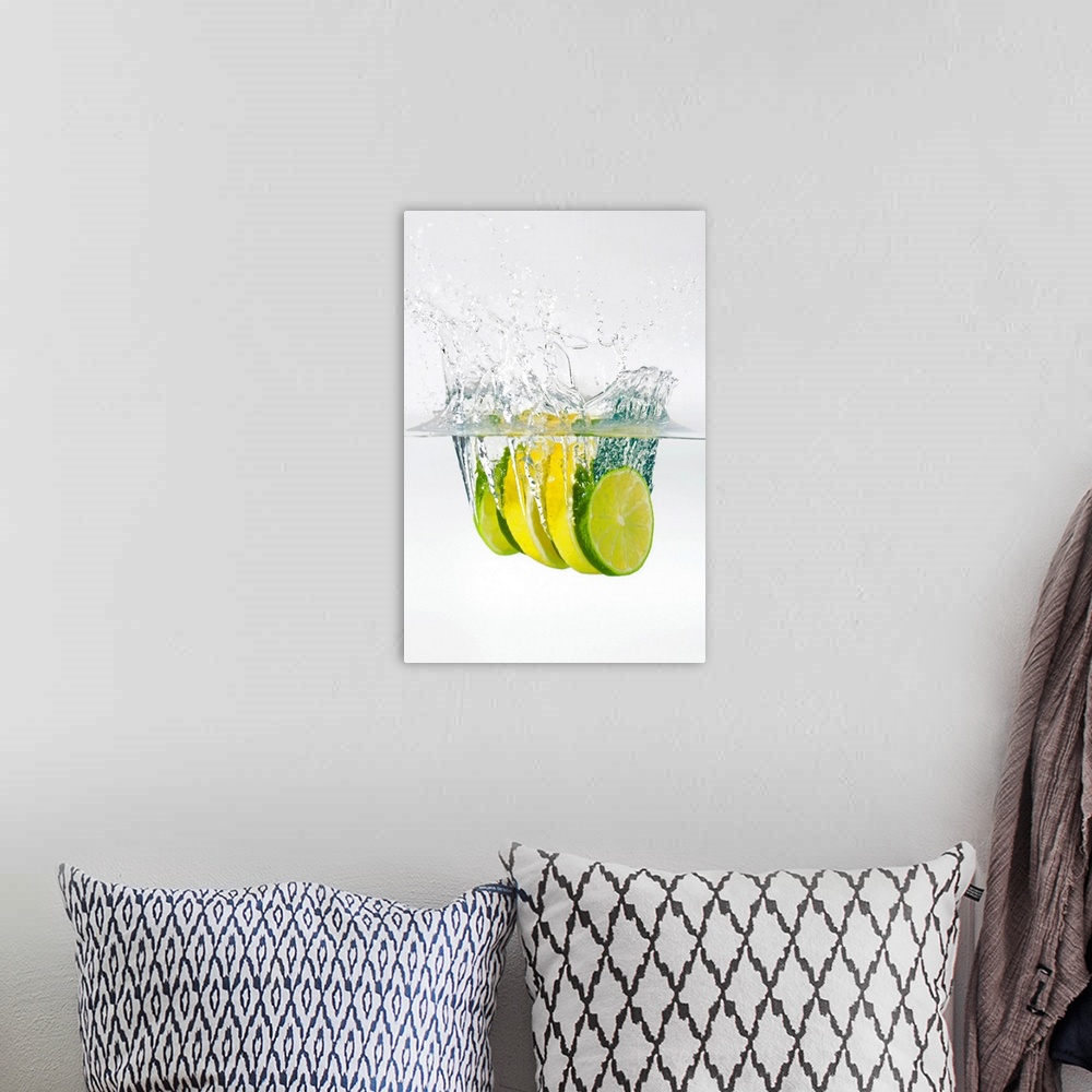 A bohemian room featuring Huge photograph displays four slices of fruit as they splash into water.