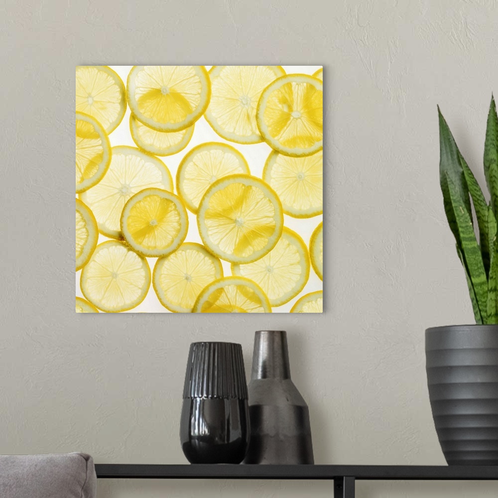 A modern room featuring This large piece is of all different sized lemon slices that have been laid onto an illuminated s...
