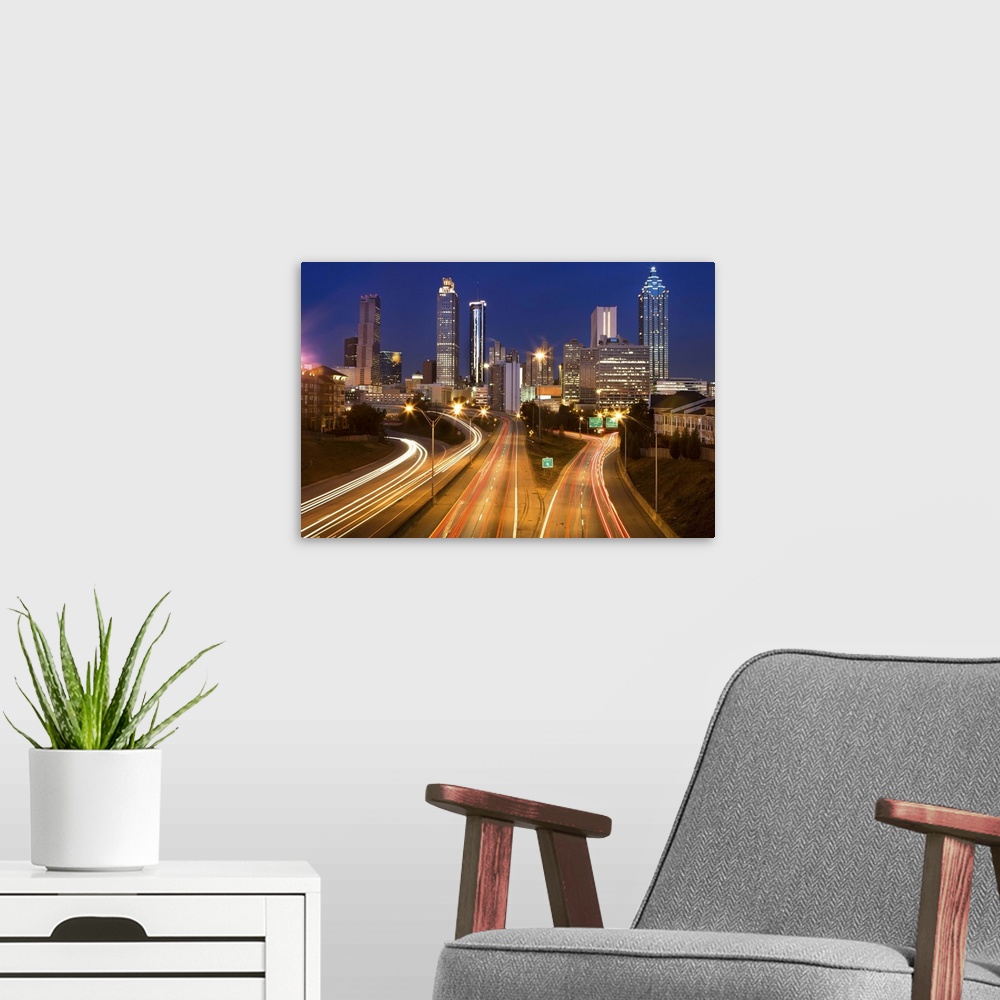 A modern room featuring Atlanta city office buildings and highway traffic motion blur