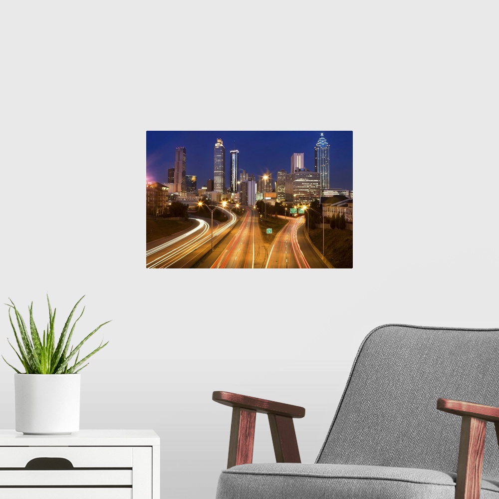 A modern room featuring Atlanta city office buildings and highway traffic motion blur