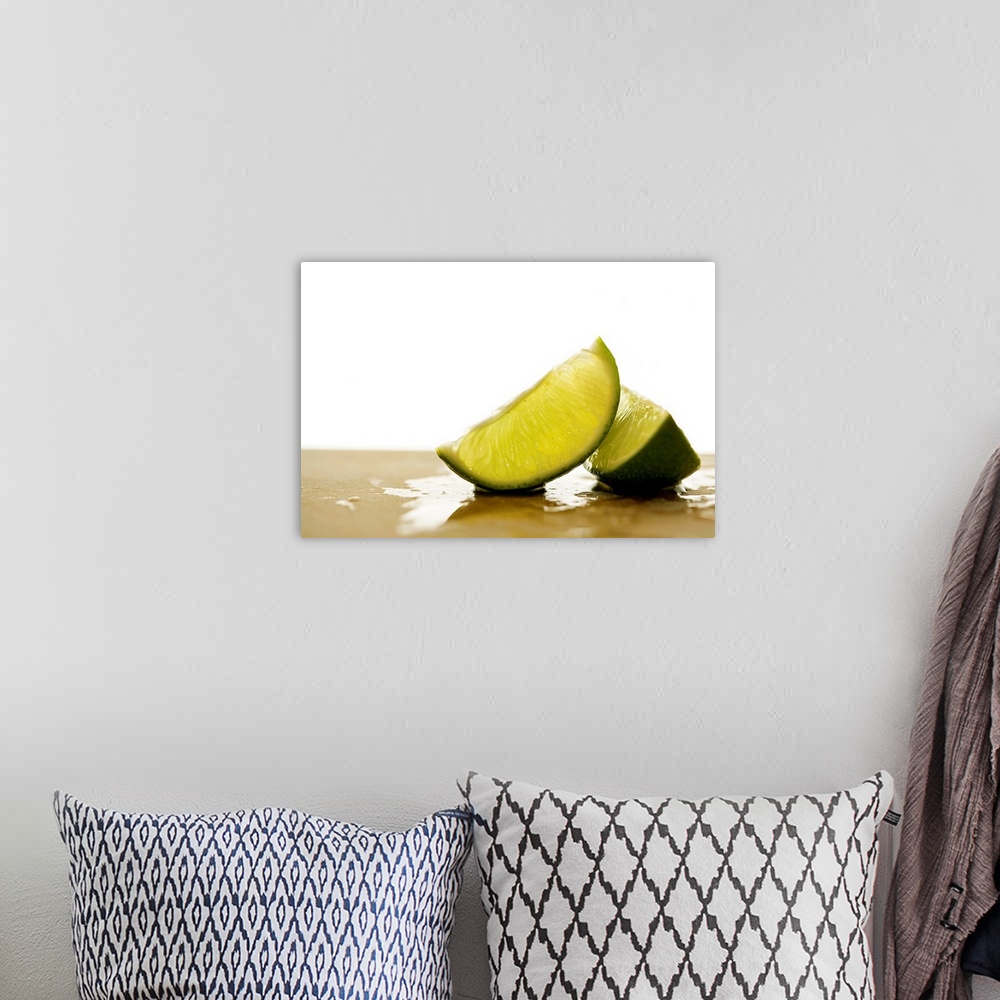 A bohemian room featuring Two slices of citrus fruit on a cutting board with a blank out of focus background.