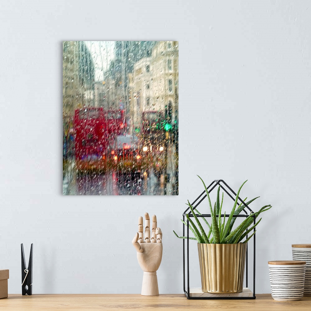 A bohemian room featuring View of red double Decker buses and yellow taxis in rain in London Piccadilly Circus.