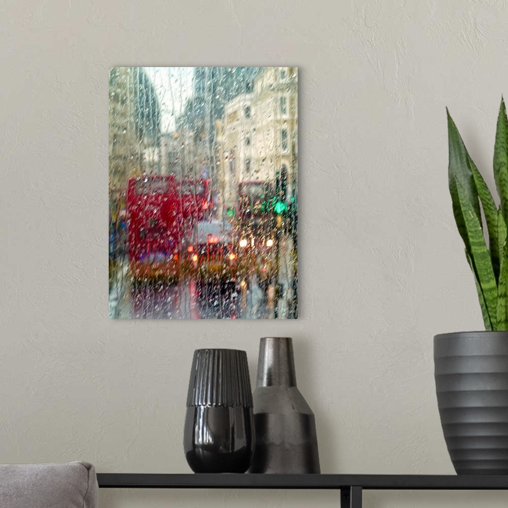 A modern room featuring View of red double Decker buses and yellow taxis in rain in London Piccadilly Circus.
