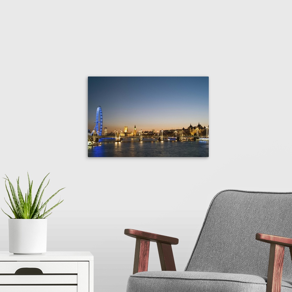 A modern room featuring UK, London, view along River Thames towards Houses of Parliament and Millennium Wheel at dusk