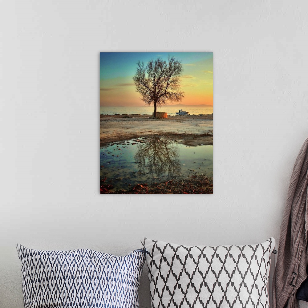 A bohemian room featuring After rain fisherman sailing out of port with lone tree reflection in water.