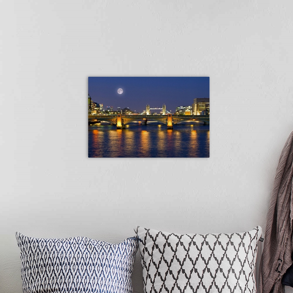 A bohemian room featuring Horizontal photograph on a giant wall hanging of the Millennium Footbridge, lit at night over the...