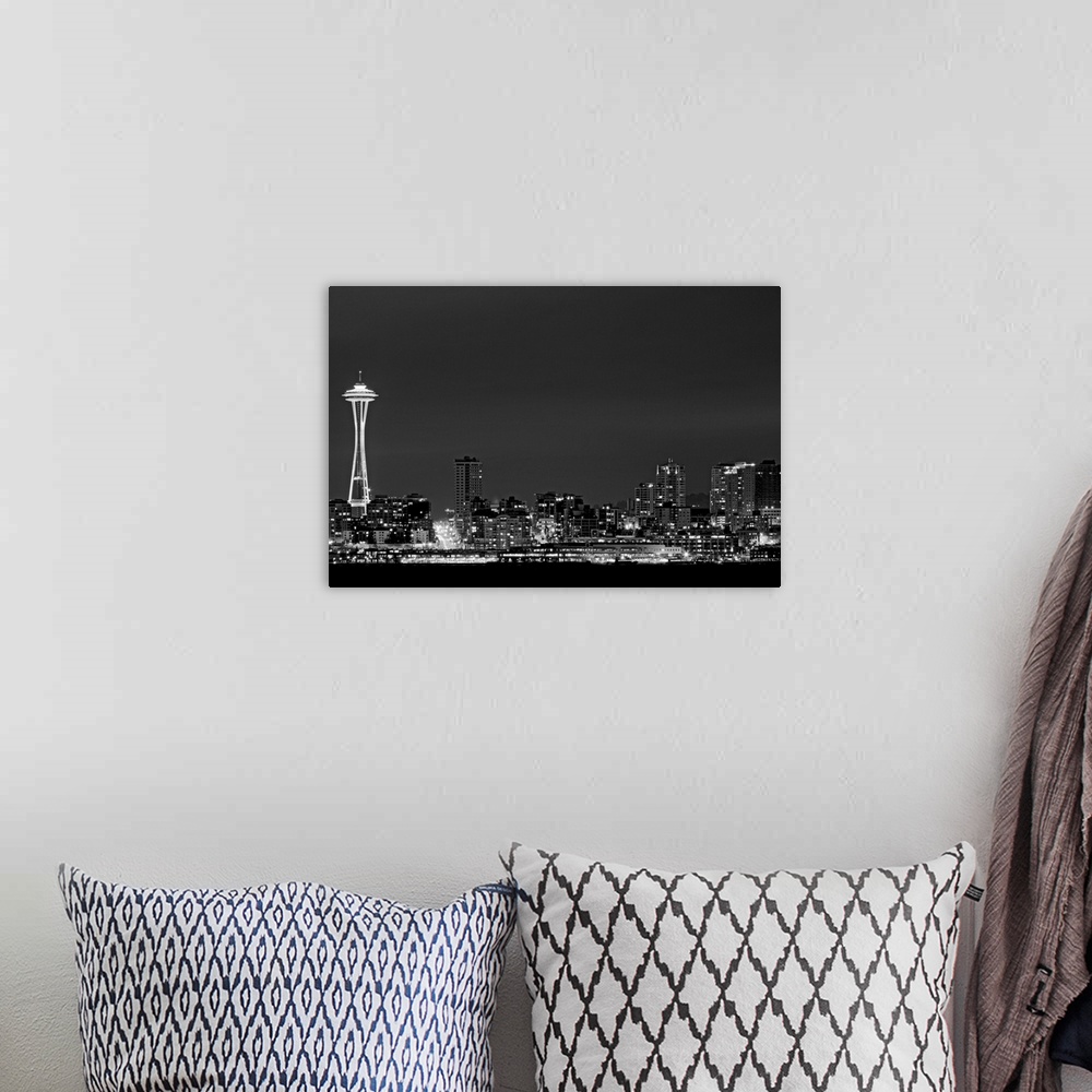 A bohemian room featuring Black and white photograph taken of the city skyline in Seattle with the city illuminated under a...