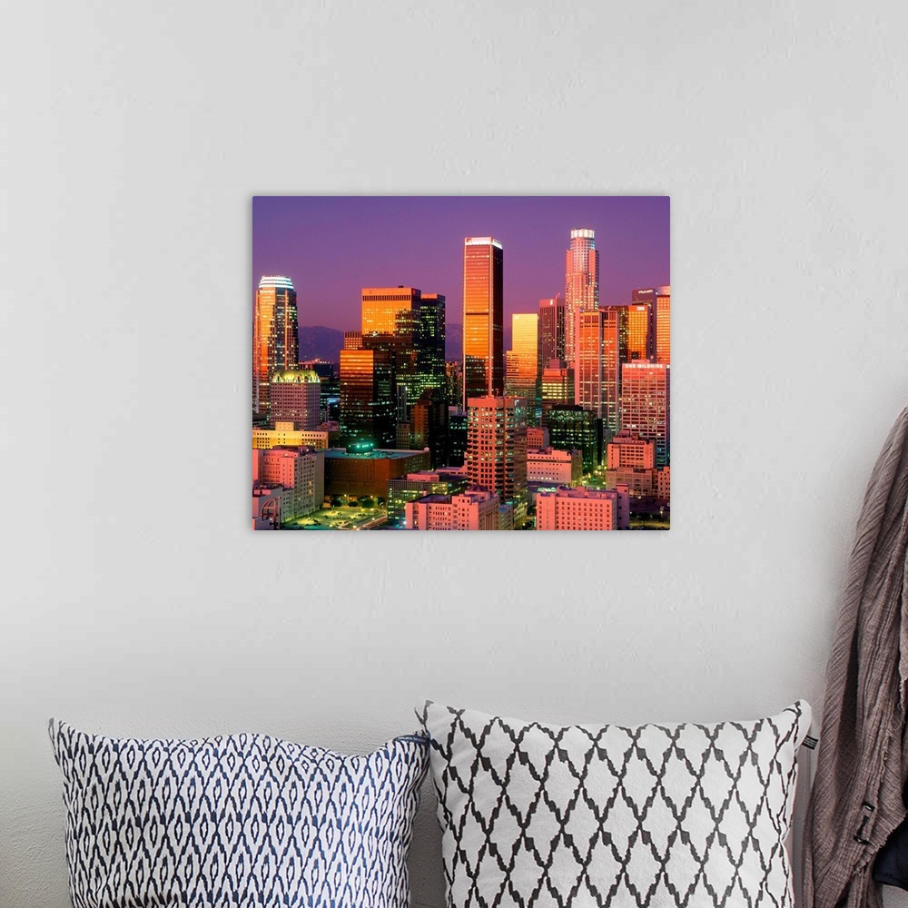 A bohemian room featuring Landscape, close up photograph on a large wall hanging of brightly lit skyscrapers in downtown Lo...