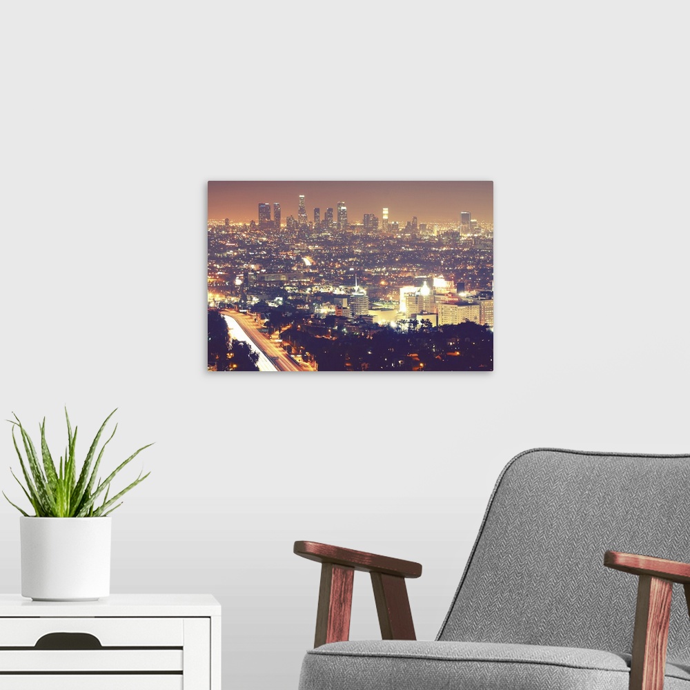 A modern room featuring Los Angeles skyline city at night.