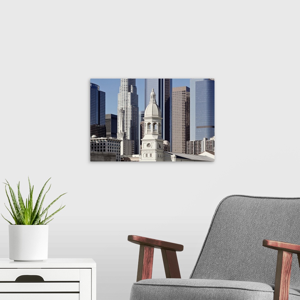 A modern room featuring Los Angeles skyscraper buildings at midday under clear blue sky.