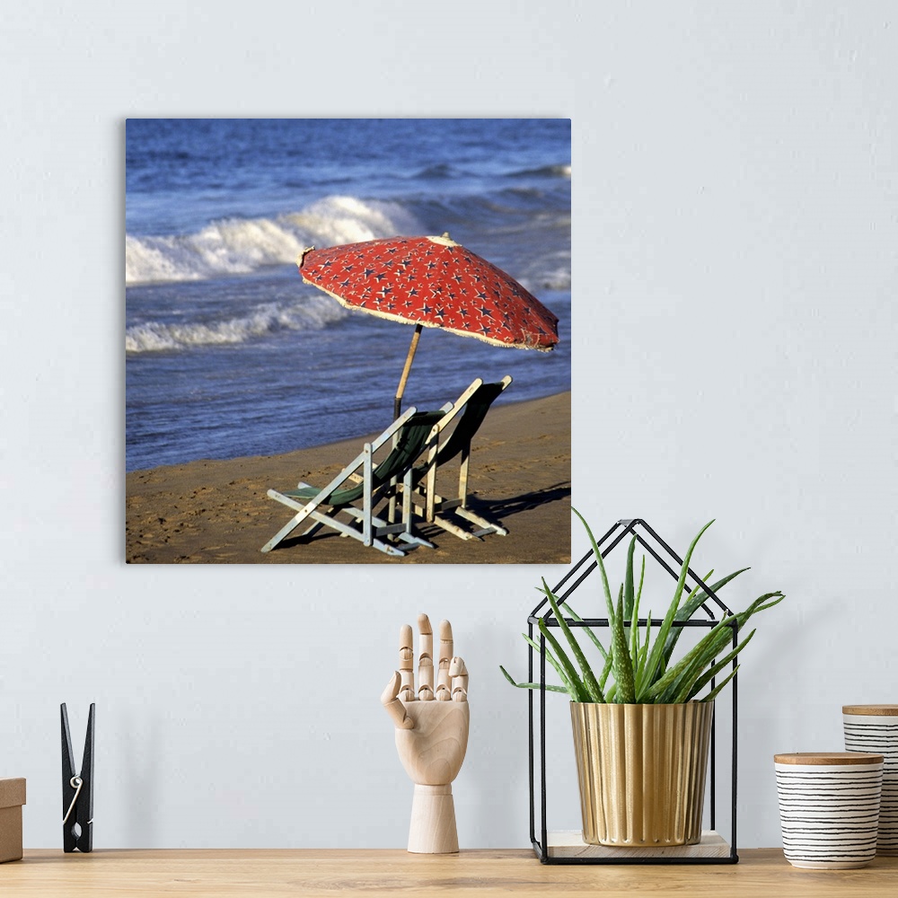 A bohemian room featuring Lounge chairs under a beach umbrella