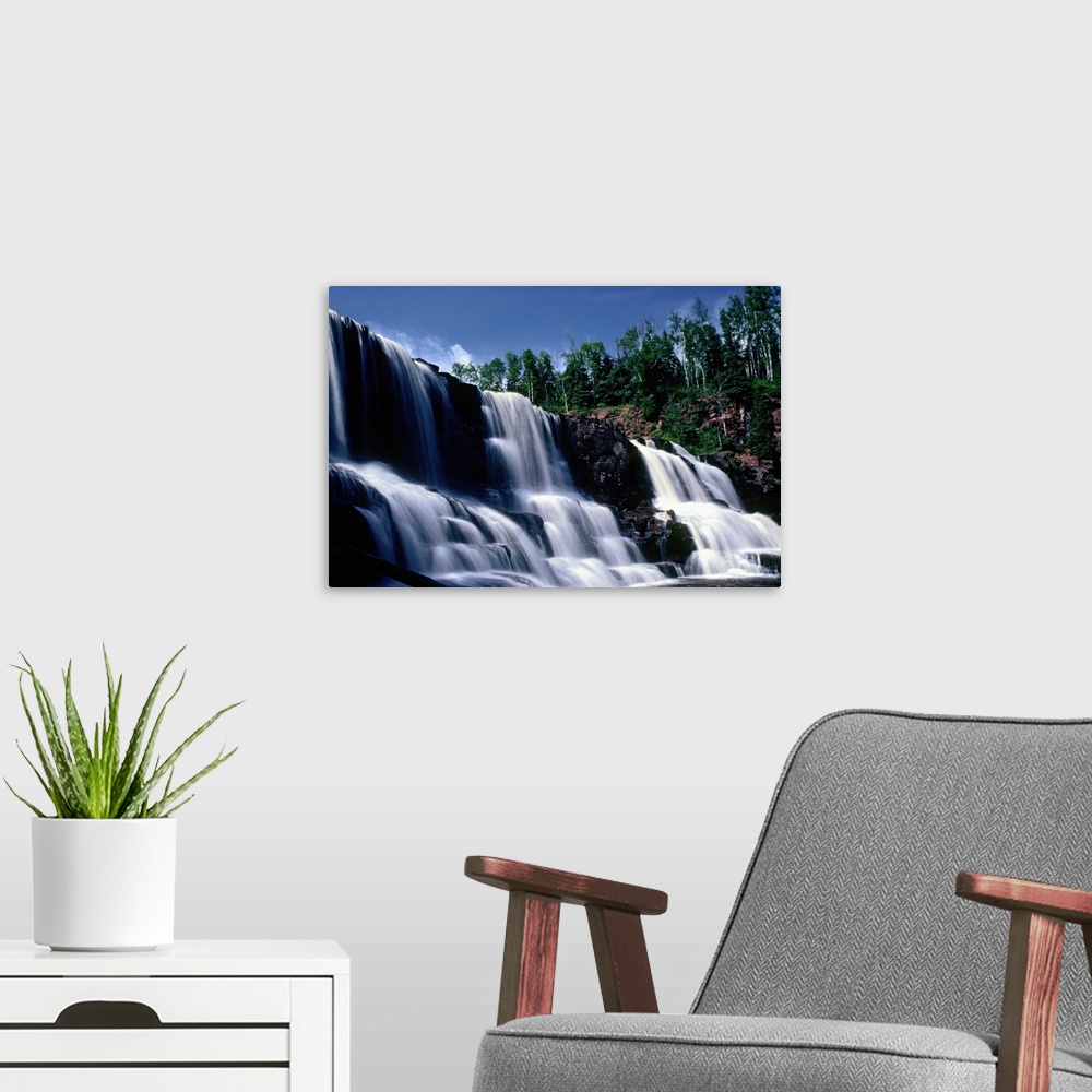 A modern room featuring Low angle view of three waterfalls