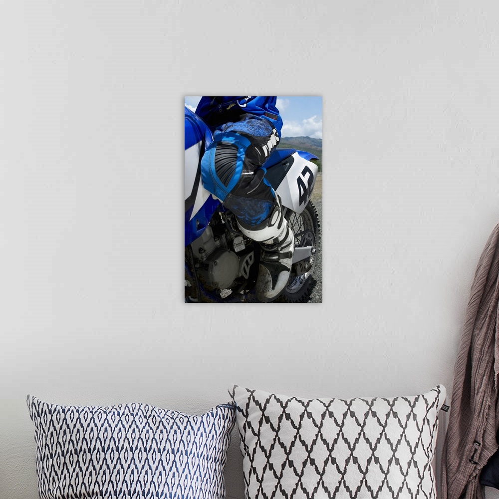 A bohemian room featuring Low section view of a motocross rider riding a motorcycle
