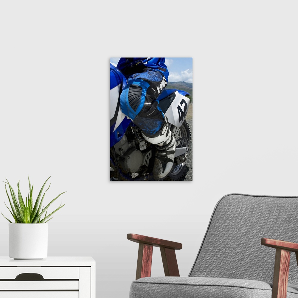 A modern room featuring Low section view of a motocross rider riding a motorcycle