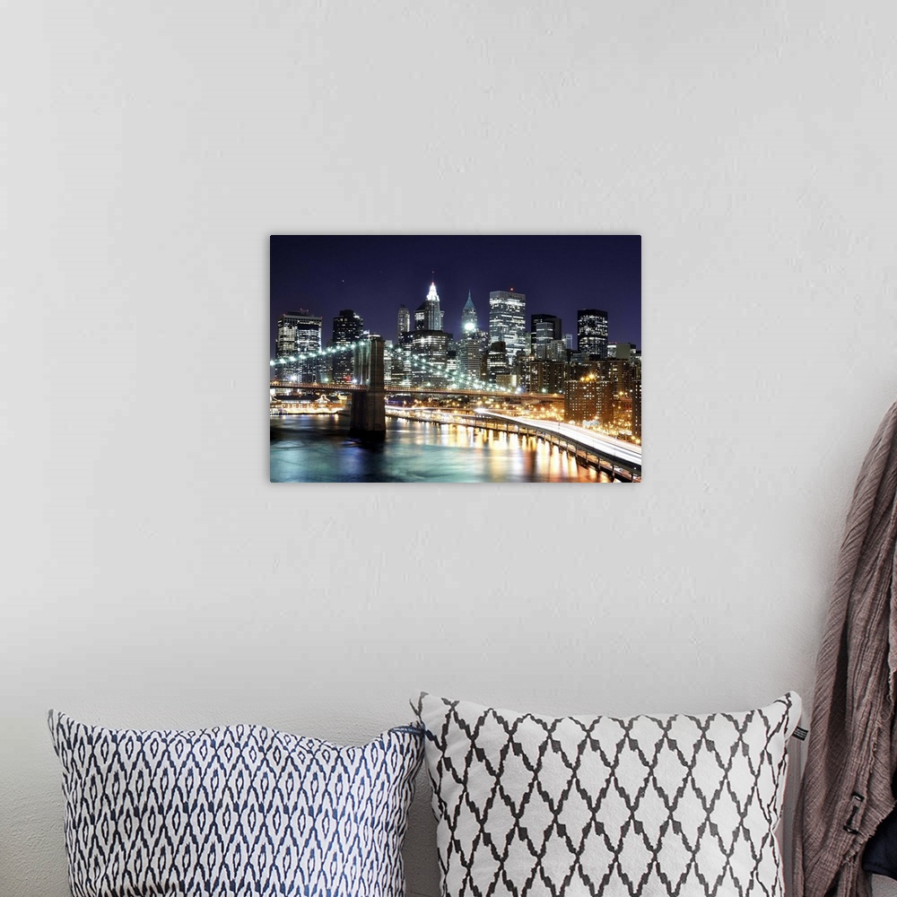 A bohemian room featuring Aerial view of lower Manhattan including the financial district and the Brooklyn Bridge at night.