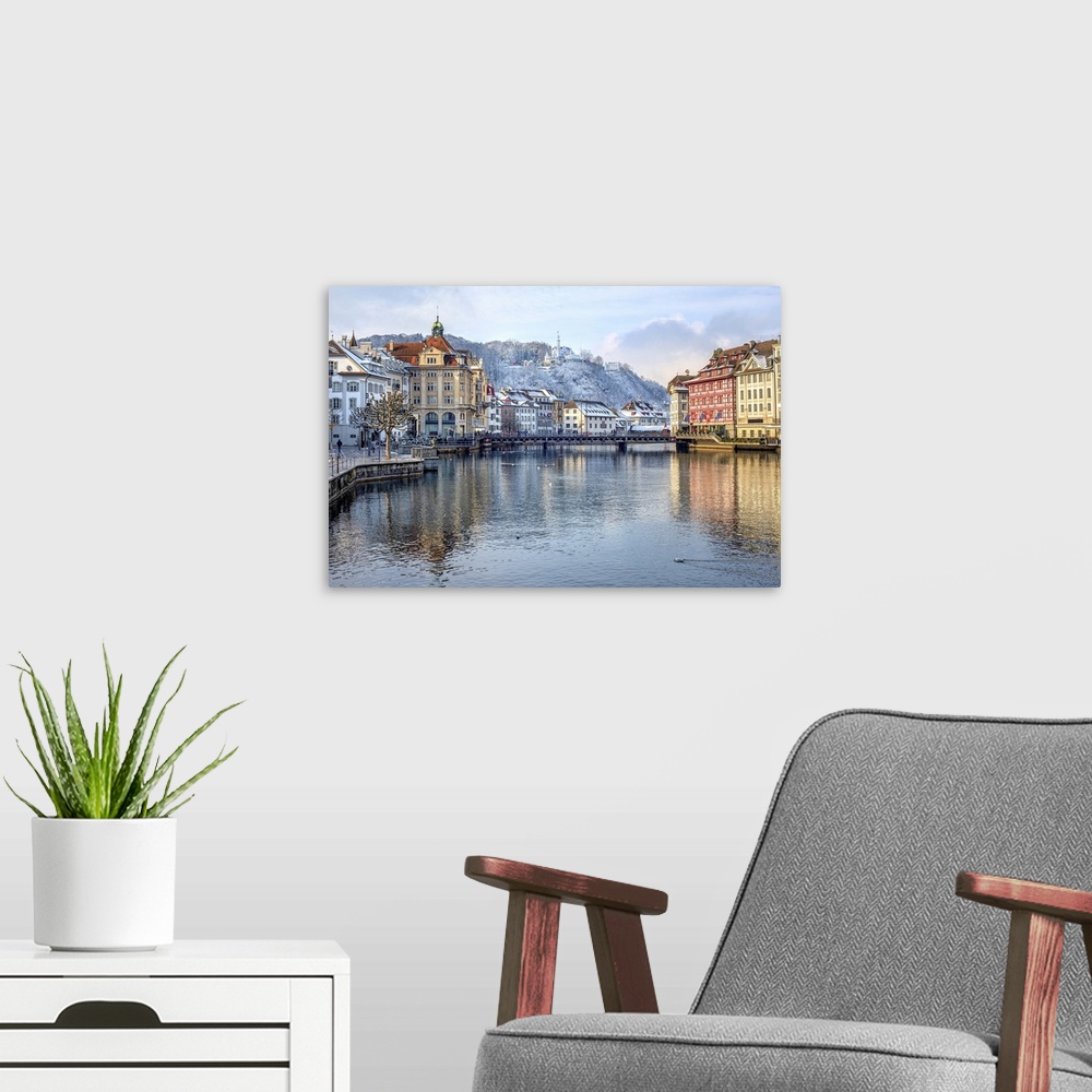 A modern room featuring Lucerne city, Switzerland, view of the Old Town covered with white snow in winter, reflecting in ...