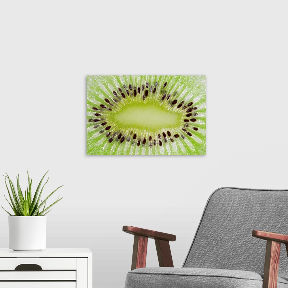 A modern room featuring Large closeup photograph of the inside of a sliced kiwi fruit.