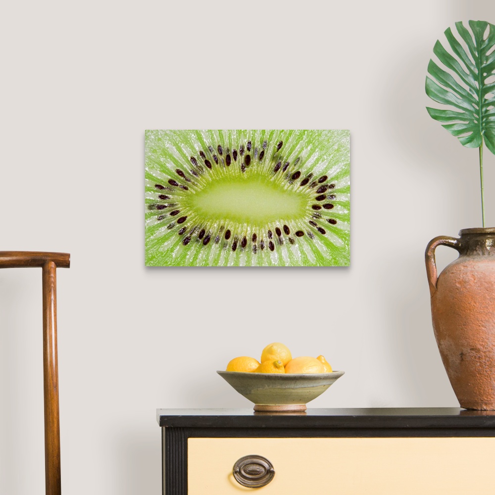 A traditional room featuring Large closeup photograph of the inside of a sliced kiwi fruit.
