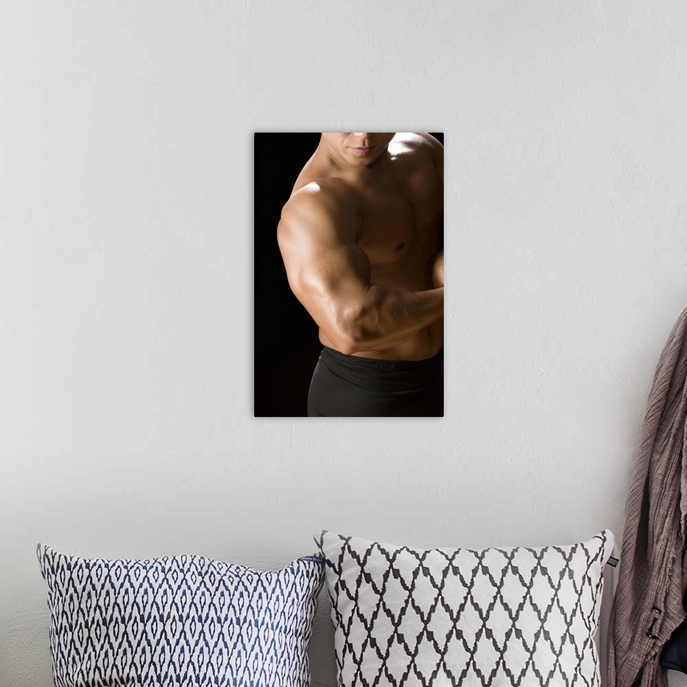A bohemian room featuring Male bodybuilder flexing muscles, front view, black background