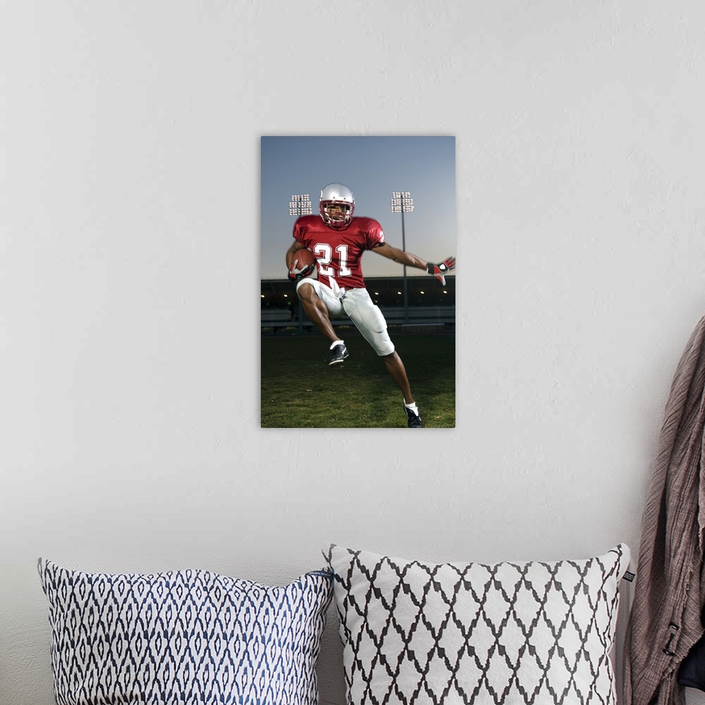 A bohemian room featuring Male football player carrying football