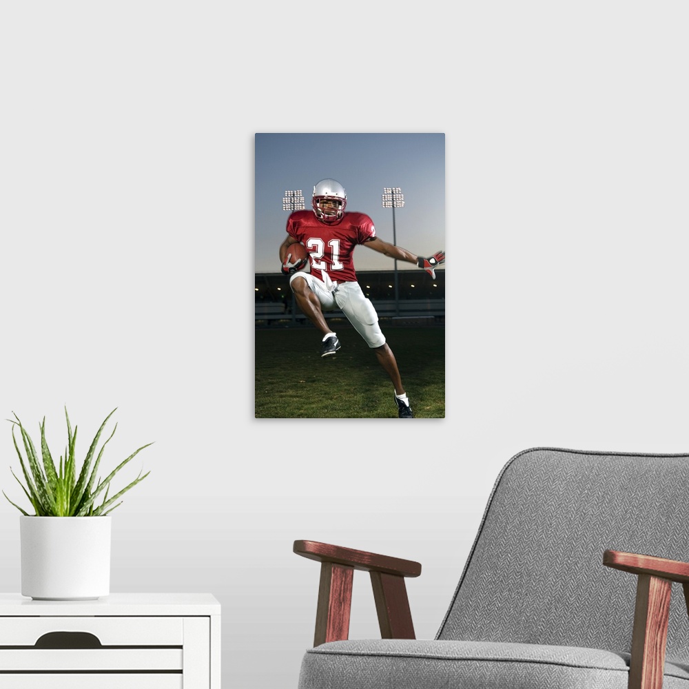 A modern room featuring Male football player carrying football