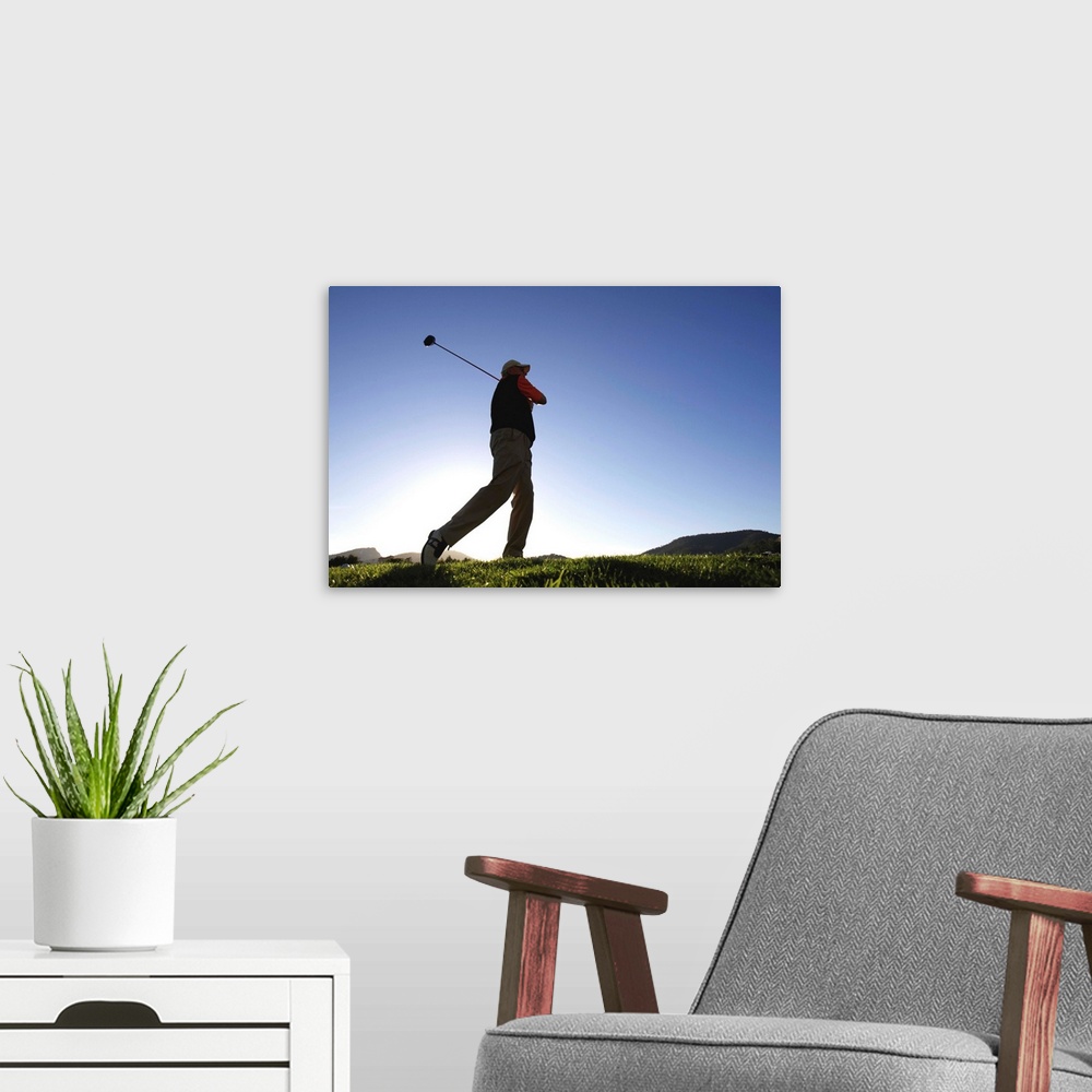 A modern room featuring Male golfer, low angle view