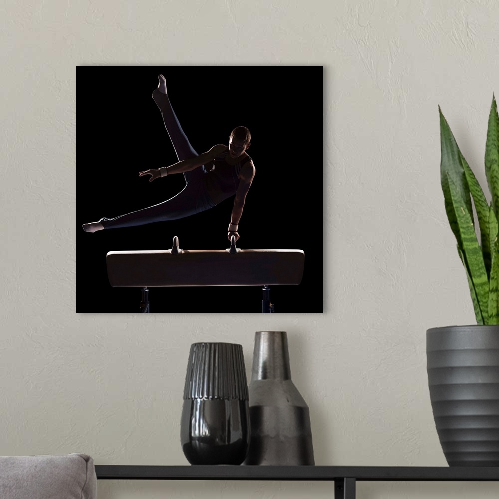 A modern room featuring Male gymnast on pommel horse